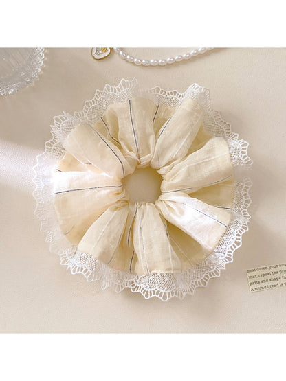 Flat lay of Gifty striped ruched scrunchie on a neutral background