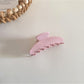 Beau hair clip angled to show thickness and glossy finish of acetate material