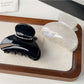 Beau hair claw clip in matte black, top view highlighting smooth finish