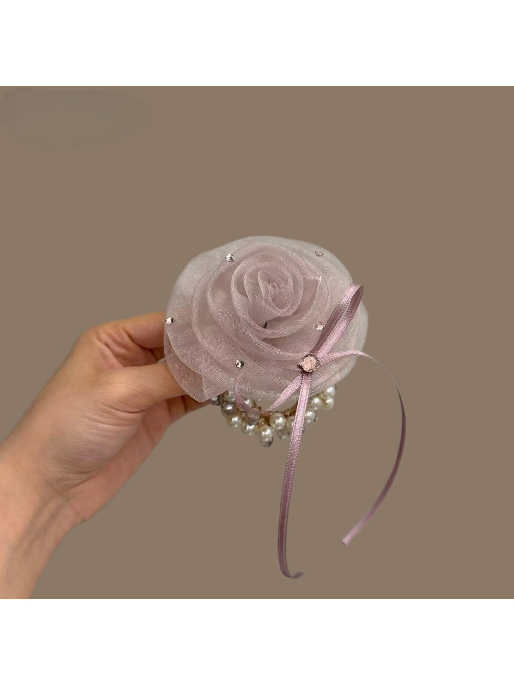 Chic hair tie with a large white flower embellishment on a black elastic band