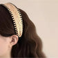 Close-up of the textured fabric and stitching details of the bohemian wide headband