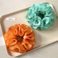 Gifty minimalist scrunchie stretched slightly to show elasticity