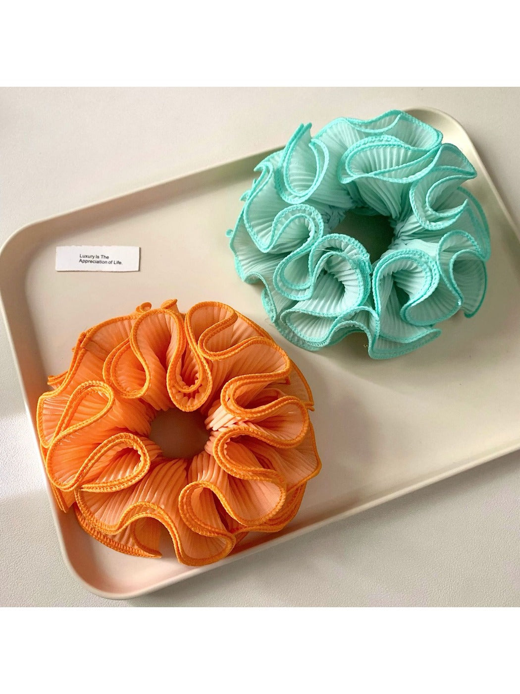 Gifty minimalist scrunchie stretched slightly to show elasticity