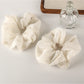 Close-up of Gifty timeless versatile fashion scrunchie in soft beige fabric
