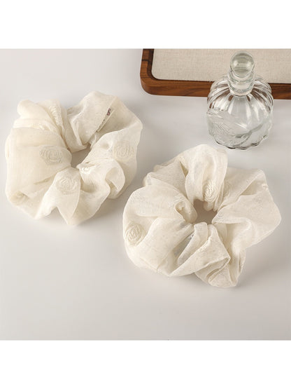 Close-up of Gifty timeless versatile fashion scrunchie in soft beige fabric