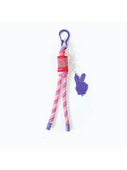 User pulling the retractable cord of the colorful Keypus keychain