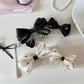 Beau stylish polka dot bow banana clip on white background
