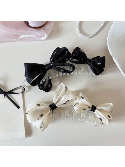 Beau stylish polka dot bow banana clip on white background