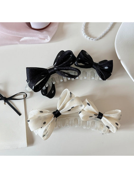 Beau stylish polka dot bow banana clip on white background