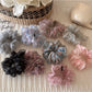 Colorful ditsy floral scrunchie on a white background