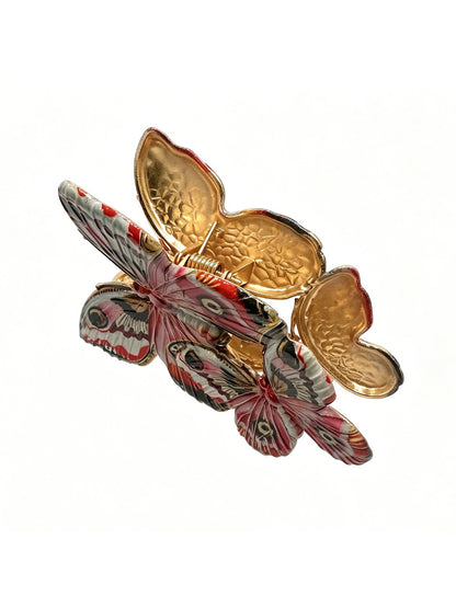 Red butterfly hair clip displayed on white background showing full design