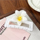 Beau square ombre flower shaped claw clip photographed with soft lighting emphasizing ombre colors
