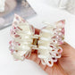 Beau double layer hollow bow shaped claw clip displayed open to show teeth