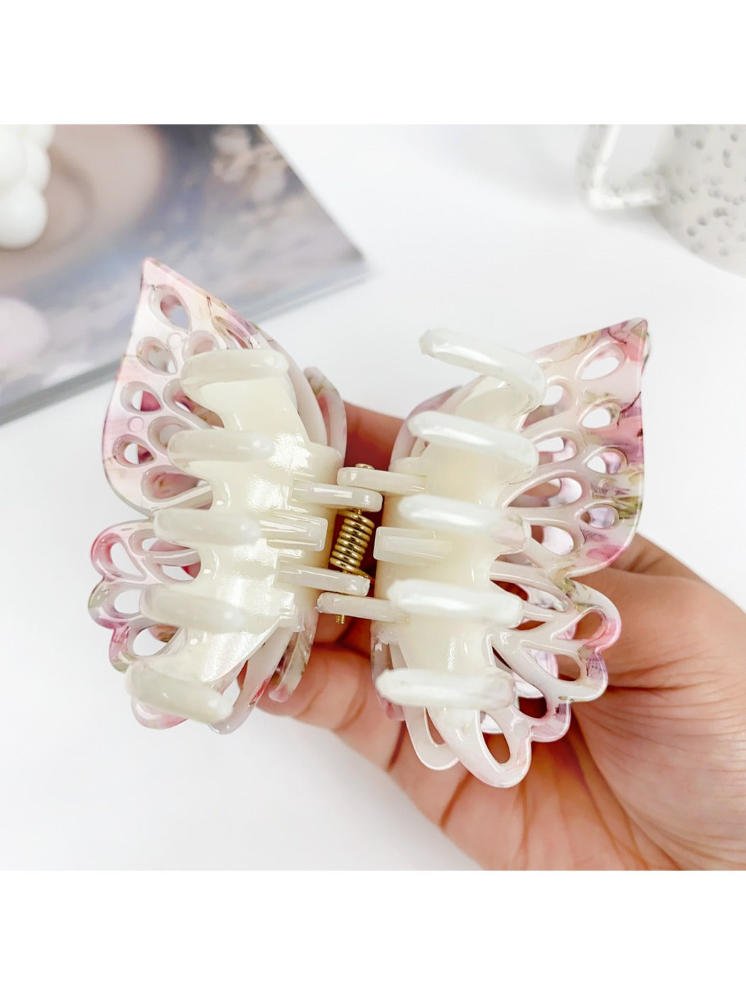 Beau double layer hollow bow shaped claw clip displayed open to show teeth