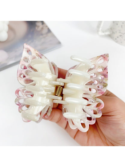 Beau double layer hollow bow shaped claw clip displayed open to show teeth