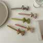 Beau bow bar hair clip held in hand to show size and lightweight design