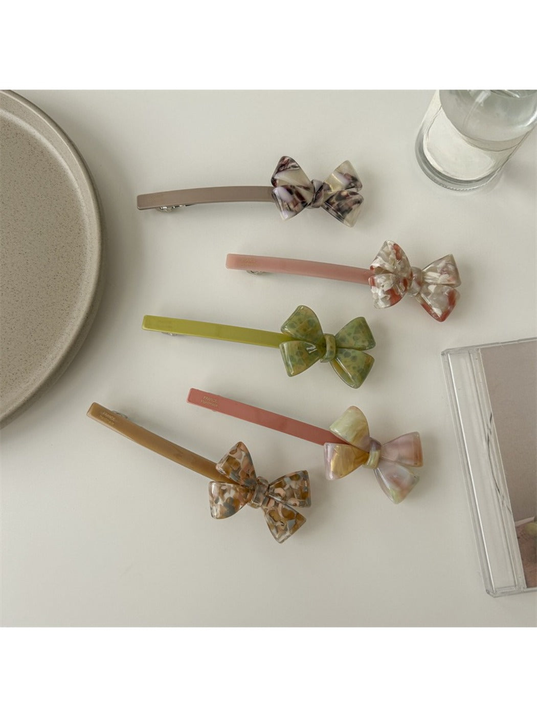 Beau bow bar hair clip held in hand to show size and lightweight design
