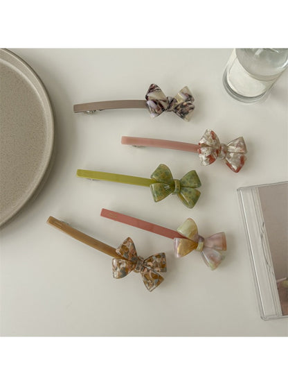 Beau bow bar hair clip held in hand to show size and lightweight design