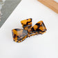 Beau minimalist bow claw clip in natural light showing subtle shadows