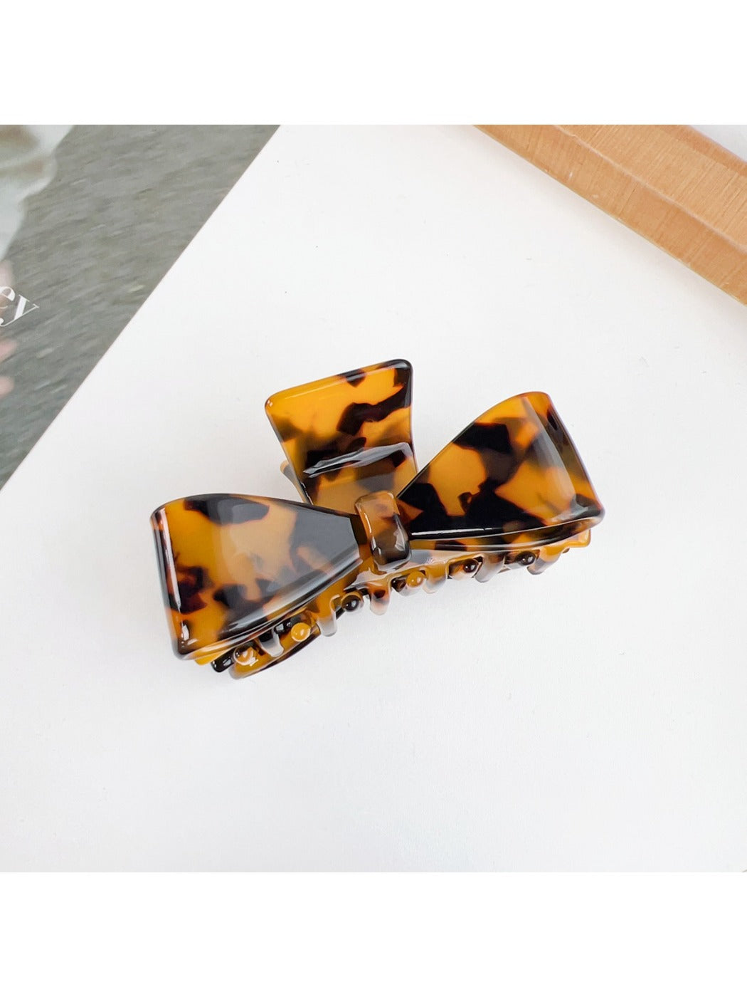 Beau minimalist bow claw clip in natural light showing subtle shadows