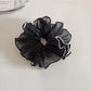 Gifty ruffled scrunchie packaged in a clear plastic bag with branding