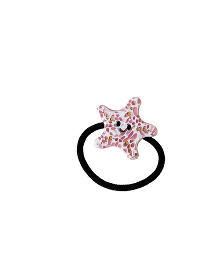 Gifty hair tie wrapped around wrist showing colorful ocean animal pattern