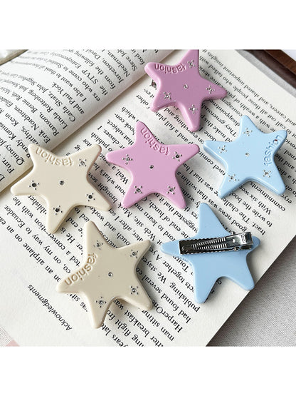 Beau acetate star-shaped hair clip on white background
