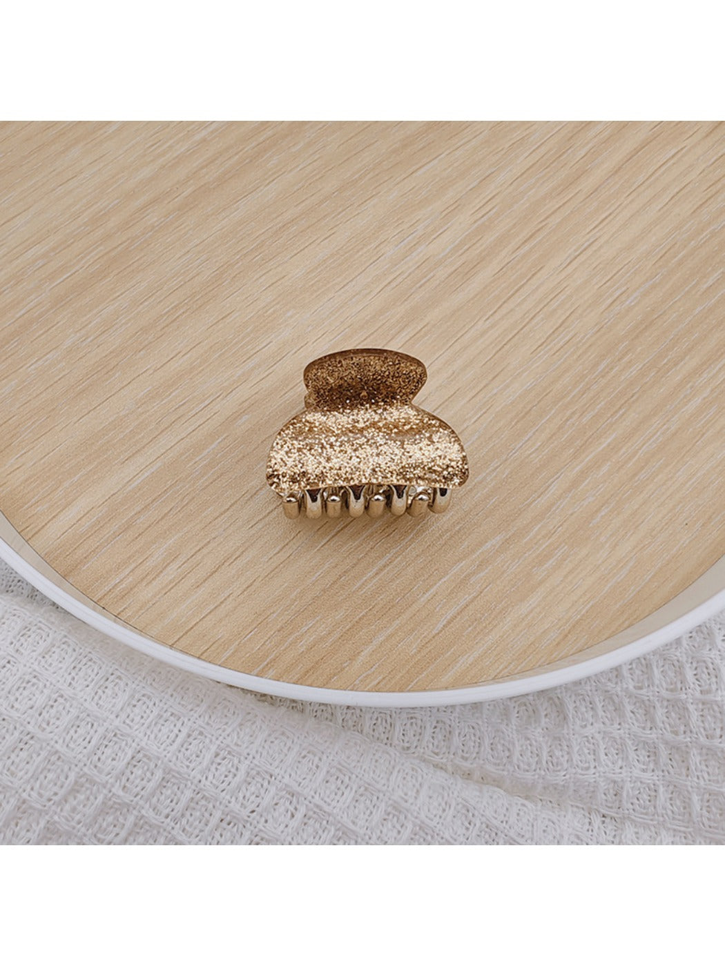 Beau medium half ponytail claw clip in neutral beige tone on wooden surface