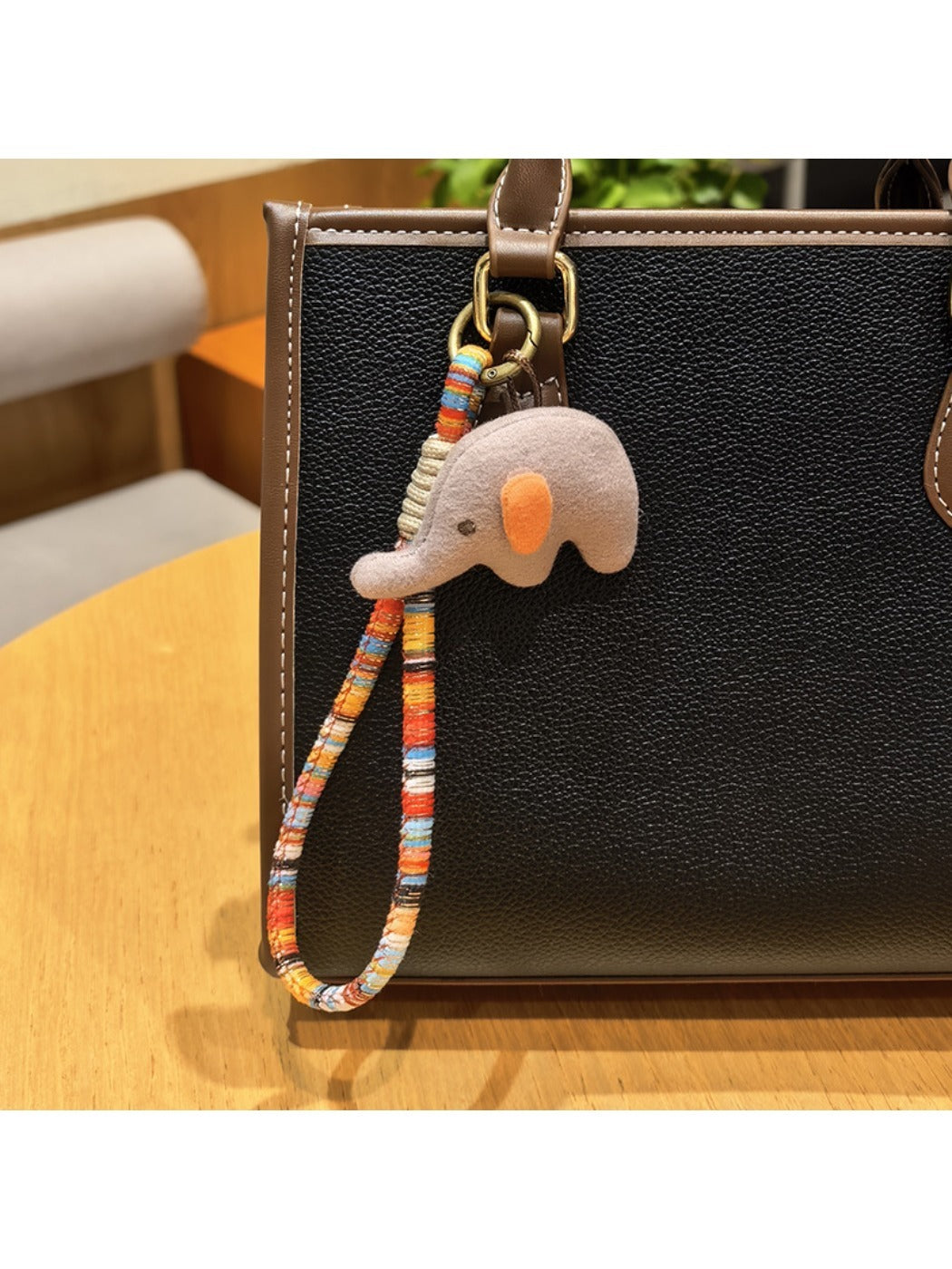 Elephant charm keychain with a shiny silver finish and smooth texture