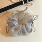 Gifty tulle ribbon bow scrunchie displayed on a wooden surface with natural light