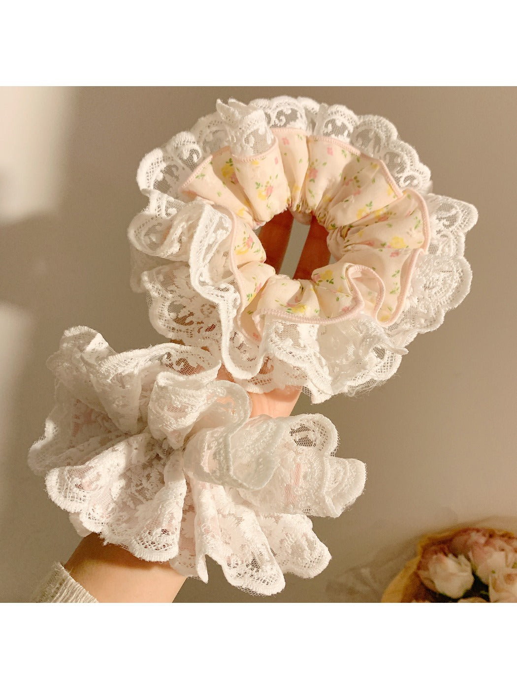 Gifty scrunchie wrapped around a ponytail in a model's hair highlighting print details