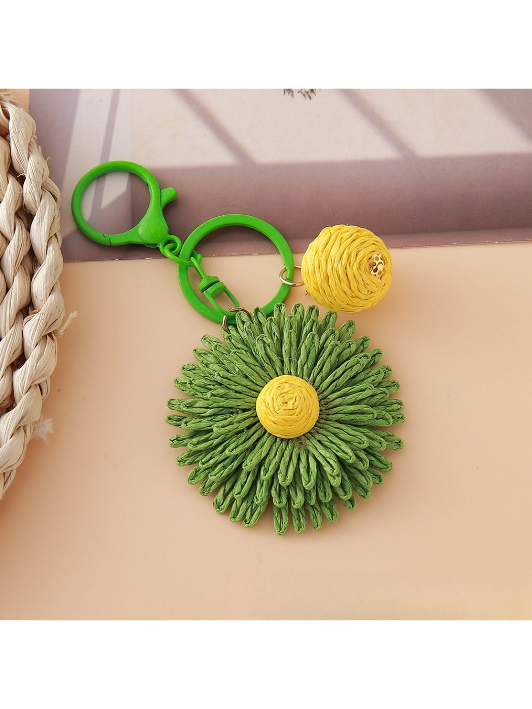 Multiple sunflower keychains arranged in a row on a flat surface