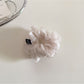 Scrunchie in solid color placed next to matching accessories