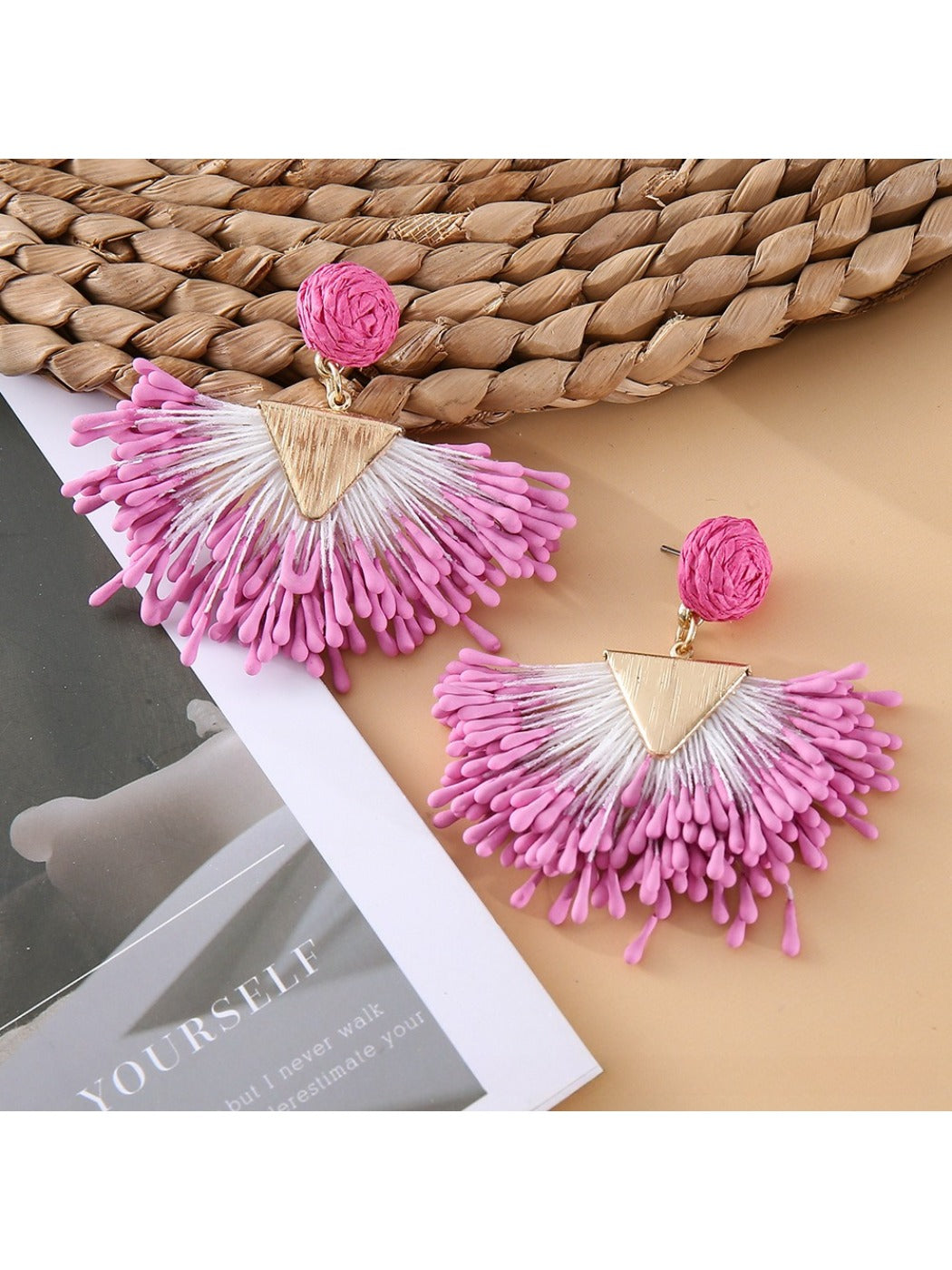 Side view of earedge raffia drop earrings showing woven texture and gold accents