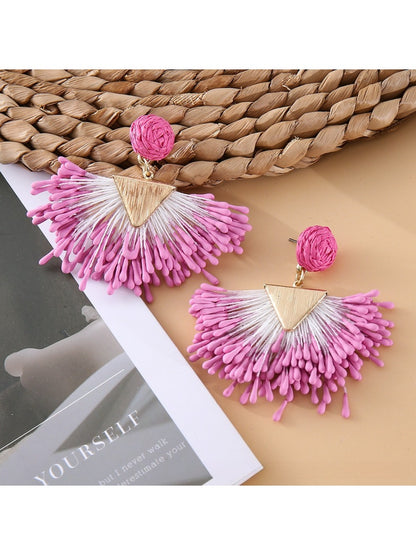 Side view of earedge raffia drop earrings showing woven texture and gold accents