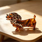 Beau claw clip held in hand showing size and cartoon dachshund design