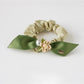 Gifty hair tie styled on a wrist as a bracelet with visible flower details