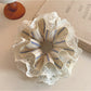 Close-up of striped lace fabric texture on the Gifty scrunchie