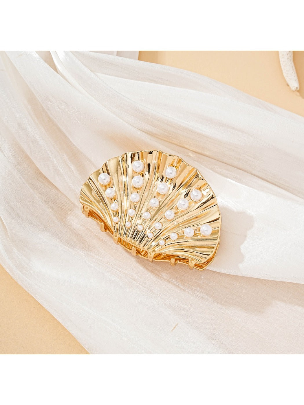 Close-up of Beau seashell hair clip showing detailed ridges and glossy finish