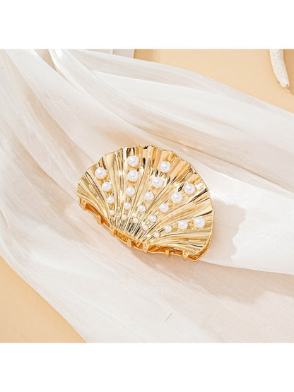 Close-up of Beau seashell hair clip showing detailed ridges and glossy finish