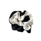 Gifty scrunchie styled with casual outfit on a wooden surface