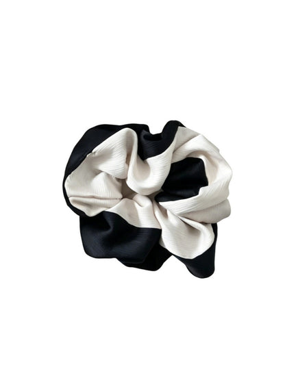 Gifty scrunchie styled with casual outfit on a wooden surface