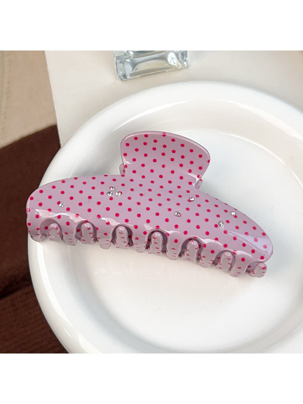 Beau sweet pink hair claw clip held in hand showing size and shape