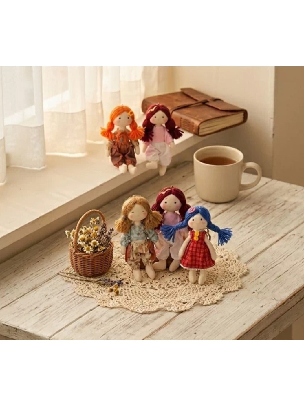 Fabric yarn doll keychain hanging from a metal keyring on a white background