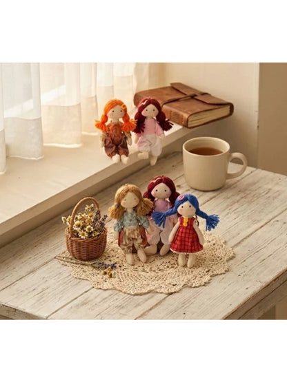 Fabric yarn doll keychain hanging from a metal keyring on a white background