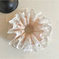Close-up of Gifty sweet light pink scrunchie on white background