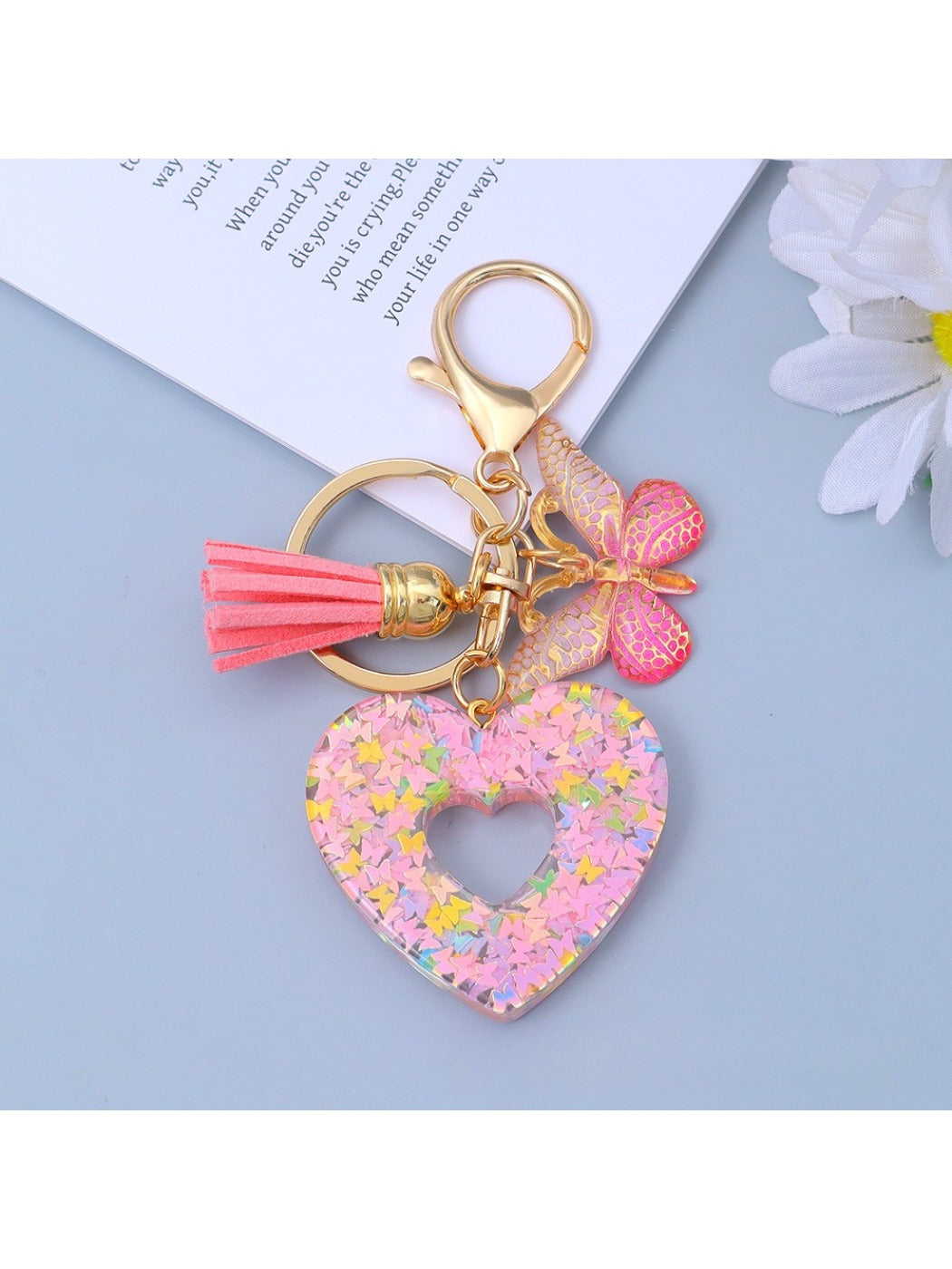 Keypus keychain with heart cutout shown hanging from a hook