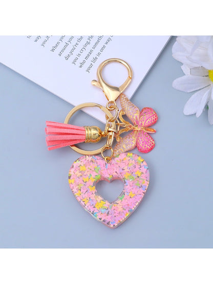 Keypus keychain with heart cutout shown hanging from a hook
