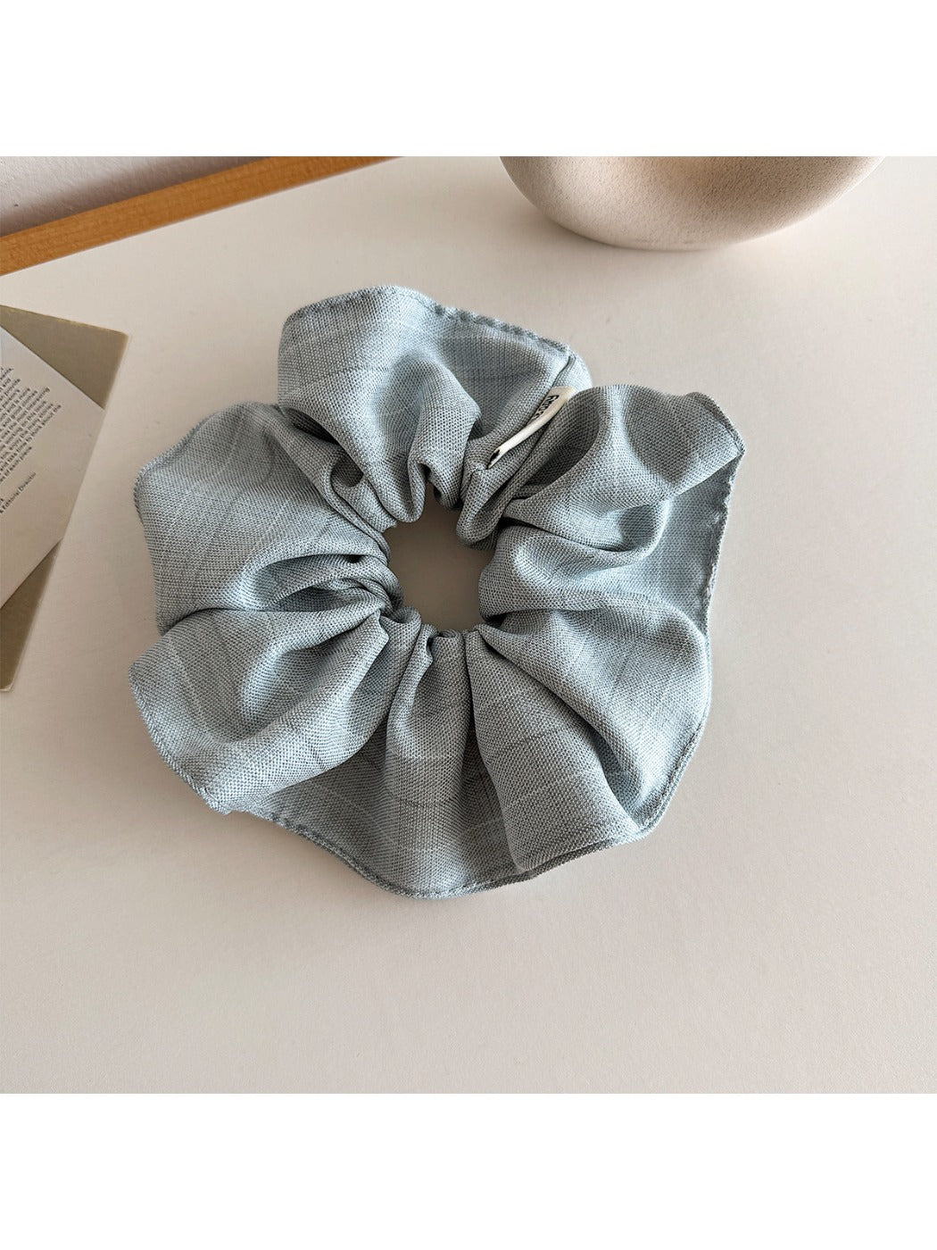Side view of vintage minimalist stripe scrunchie showing gathered fabric texture