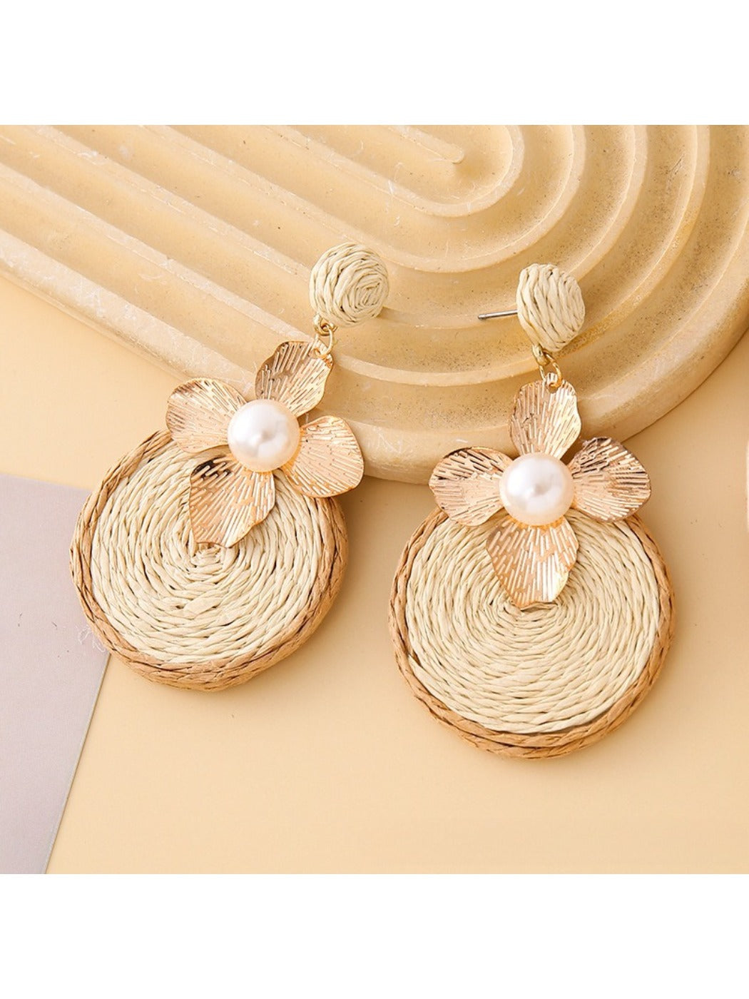Earedge earrings worn on a model showcasing length and floral circular design